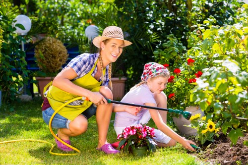 Garden clearance team removing overgrown plants and debris from a backyard
